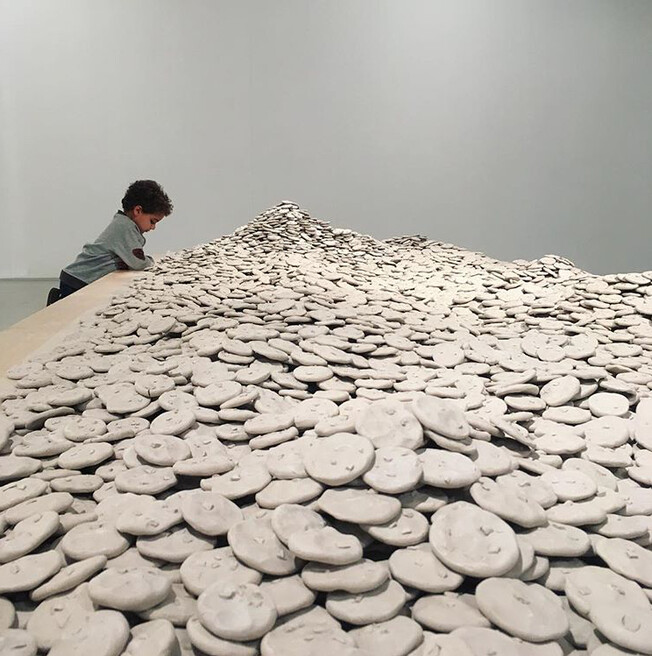 Hand-built clay (approx. 1,500 lb.), wax paper, (presented on wood plinth, 12” x 84” x 192”).