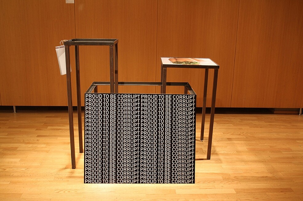 6.	Proud to be corrupt, site-specific installation, inkjet print on Dibond, six A4 prints on photo paper, plastic folders, metallic structure, variable sizes, 2018. Work produced in the frame of the KulturKontakt Austria Artist-in-Residence Program.