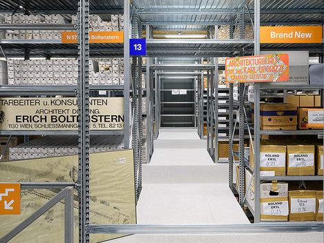 You can see a long hallway with shelves full of items.