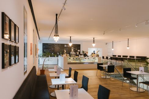 Café at mumok with seating area, counter and warm lighting in MuseumsQuartier Vienna.