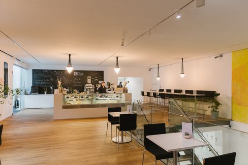 View of the mumok café with counter, bar stools and open gallery space at MuseumsQuartier.
