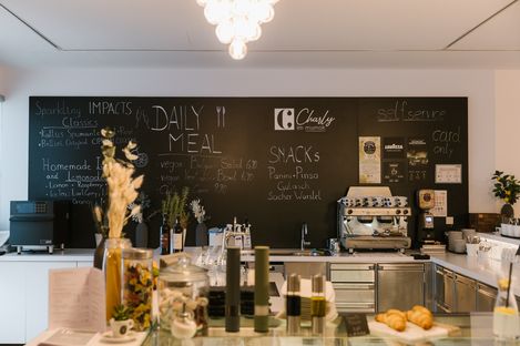 Café bar at mumok featuring a handwritten menu board and coffee machine.