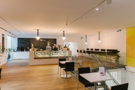 View of the mumok café with counter, bar stools and open gallery space at MuseumsQuartier.