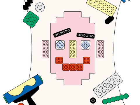 Bunte Legosteine bilden auf einem weißen Blatt ein stilisiertes Gesicht mit Augen, Nase, Mund und Augenbrauen.
