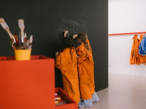 Children are drawing on the blackboard