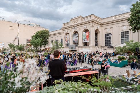 Many people in front of the MQ Summer Stage in the MQ main courtyard