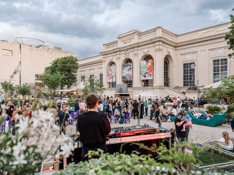 Many people in front of the MQ Summer Stage in the MQ main courtyard