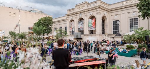 Many people in front of the MQ Summer Stage in the MQ main courtyard