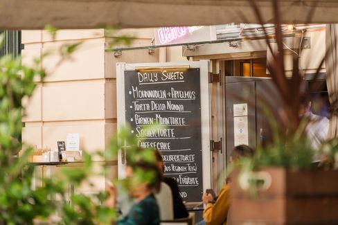Close-up of a handwritten dessert menu at an outdoor dining area in MuseumsQuartier.