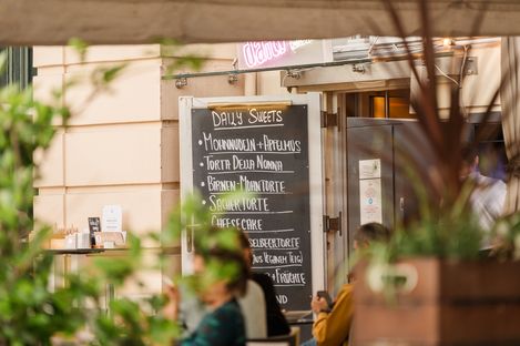 Close-up of a handwritten dessert menu at an outdoor dining area in MuseumsQuartier.