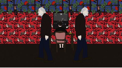 Two older men in dark clothing walk past a table where a person with black hair is seated, in front of a wall with red and blue floral patterns.