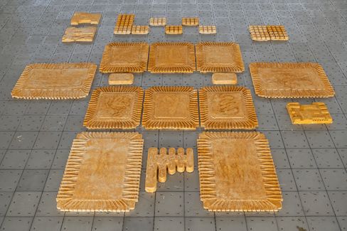 Several rectangular and square wooden plates with serrated edges and various patterns arranged on a gray grid surface.