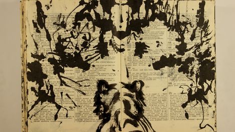 Black-and-white ink drawing on an open book with Chinese and English text showing abstract shapes and lines.