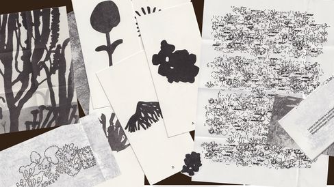 Several black-and-white sheets with abstract and floral patterns and handwritten texts overlapping on a light surface.