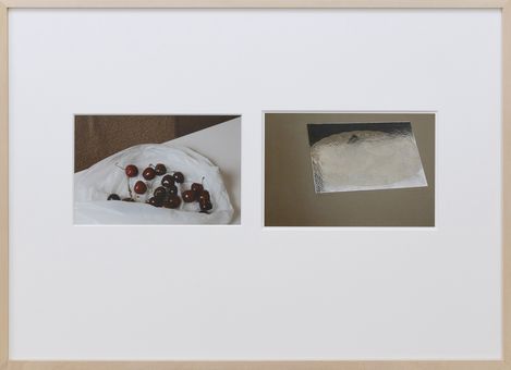 Two photographs side by side in a white frame, left showing a close-up of cherries on white fabric, right showing a shiny silver rectangular surface on a dark background.