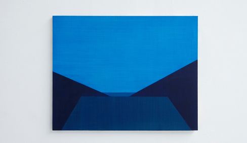 Abstract painting with geometric shapes in various shades of blue on a white wall