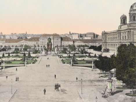 View of Maria-Theresien-Platz in Vienna with the monument in the centre, surrounded by symmetrically laid out gardens and large buildings on both sides, with the MuseumsQuartier Wien, formerly the Imperial Stables, behind it
