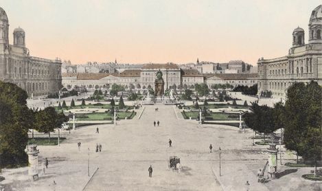 View of Maria-Theresien-Platz in Vienna with the monument in the centre, surrounded by symmetrically laid out gardens and large buildings on both sides, with the MuseumsQuartier Wien, formerly the Imperial Stables, behind it