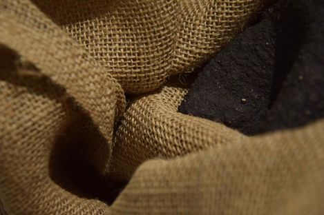 Close-up of coarse woven brown fabric with folds and shadows