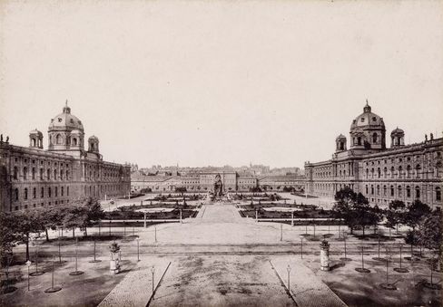 Historical image of a courtyard surrounded by old buildings.