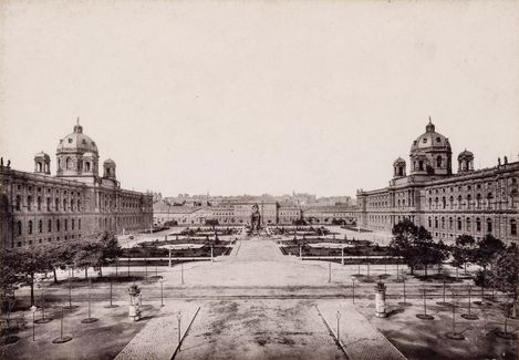 Historical image of a courtyard surrounded by old buildings.