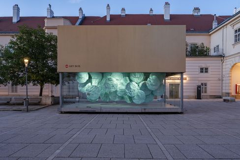 MQ Art Box in MuseumsQuartier Vienna at dusk with the illuminated installation “EMOTION” inside.