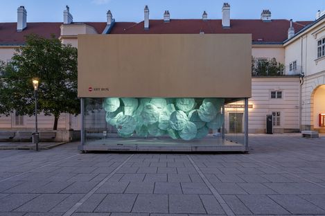 MQ Art Box in MuseumsQuartier Vienna at dusk with the illuminated installation “EMOTION” inside.