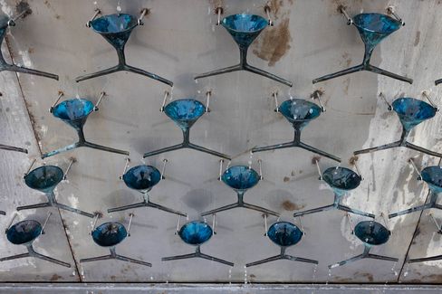 Close-up of the installation “Fountain of Exhaustion,” showing funnel-like elements arranged in a cascade with flowing water.