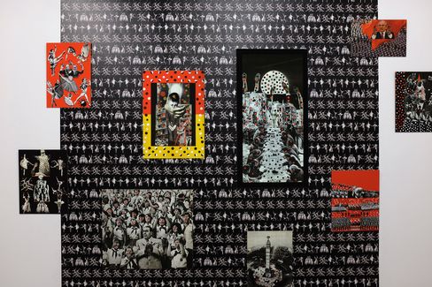 Wall with multiple black-and-white and color photographs and illustrations including skeleton figures and groups of people on a black background with small white figures.