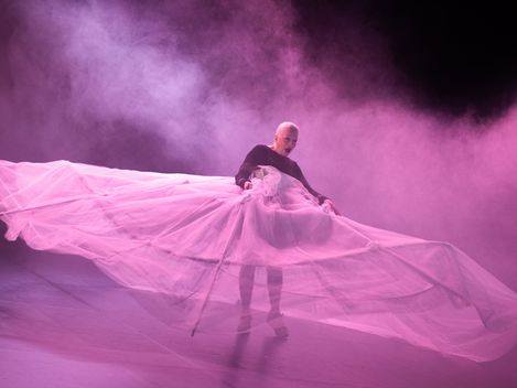 Former prima ballerina Susanne Kirnbauer stands in the pink stage mist, wearing a huge tutu