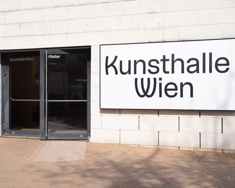 Entrance to the Kunsthalle Wien with a glass door and a light box displaying the words ‘Kunsthalle Wien’.