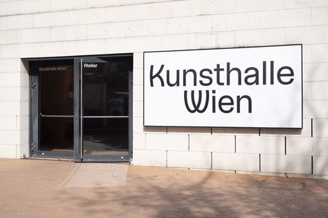 Entrance to the Kunsthalle Wien with a glass door and a light box displaying the words ‘Kunsthalle Wien’.