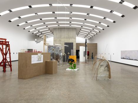 An exhibition space featuring several sculptures and paintings.