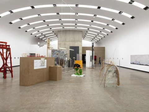 An exhibition space featuring several sculptures and paintings.