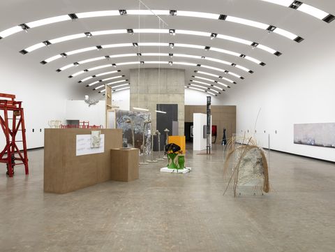 An exhibition space featuring several sculptures and paintings.