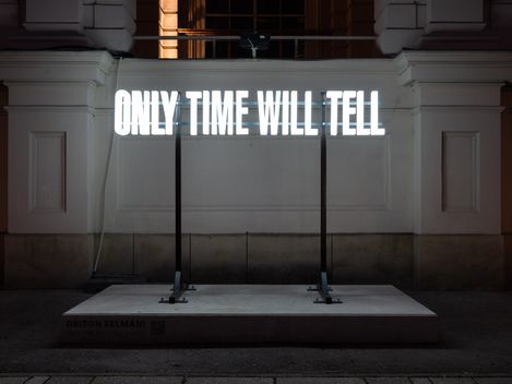 Night view of the glowing installation “Only Time Will Tell” by Driton Selmani at MQ.