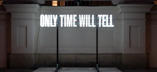 Night view of the glowing installation “Only Time Will Tell” by Driton Selmani at MQ.