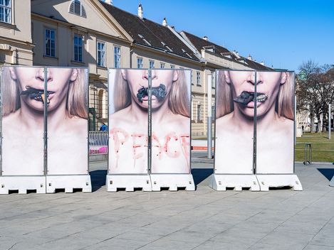 Stele installation “Peace Plan” by Inna Shevchenko in front of MuseumsQuartier Vienna featuring photographic close-ups of a face.