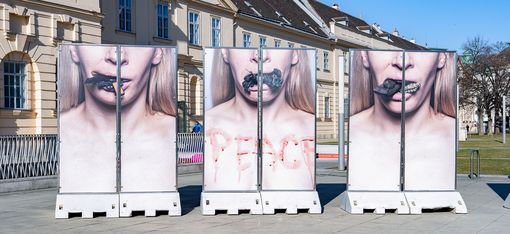 Stele installation “Peace Plan” by Inna Shevchenko in front of MuseumsQuartier Vienna featuring photographic close-ups of a face.
