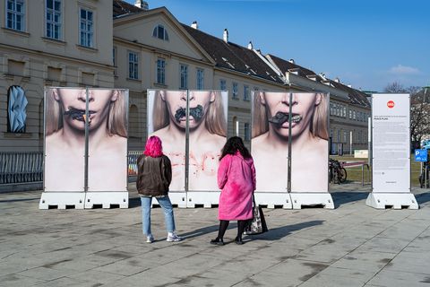 Two visitors viewing the stele installation “Peace Plan” by Inna Shevchenko at MQ Vienna.