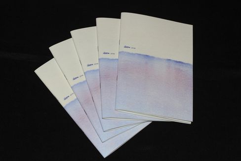 Five stacked booklets with white covers and a pale blue to violet gradient on a black background.