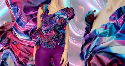 Upper body of a person wearing a sleeveless sculptural top made of multicolored gathered fabric against an abstract shiny background.