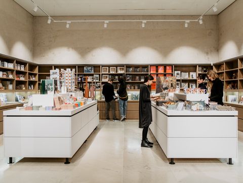 View into the Leopold Museum shop with central display tables and shelves filled with art books, design objects, and souvenirs.