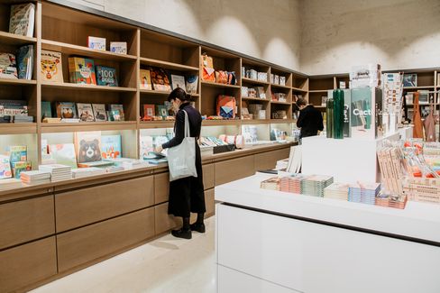 Visitors browse the shelves of the Leopold Museum shop, looking at books and design items.