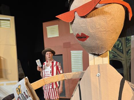 A young man is standing on the beach, slightly behind a woman. She isn’t a real person.
