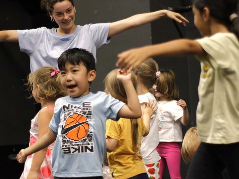 Children who love dancing perform a choreographed routine.