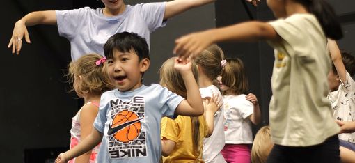 Children who love dancing perform a choreographed routine.