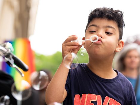 Child blows soap bubbles