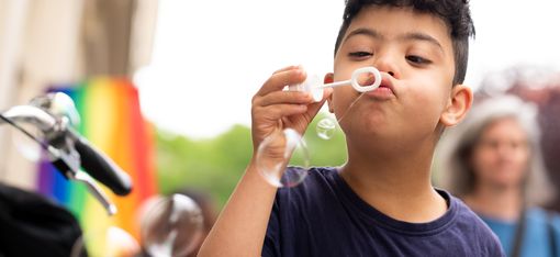 Child blows soap bubbles