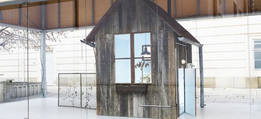 Close-up of a small weathered wooden house as part of the installation in the MQ Art Box.